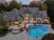 Drone shot of backyard featuring a pool, spa, and stone patio at 3685 Paces Ferry Nw Rd, Atlanta, GA 30327