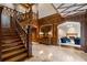 Grand foyer featuring wood paneled walls, a staircase, and marble floors at 3685 Paces Ferry Nw Rd, Atlanta, GA 30327