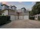 Spacious three-car garage with classic design, complemented by elegant exterior lighting and landscaping at 3685 Paces Ferry Nw Rd, Atlanta, GA 30327