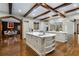 Spacious kitchen featuring large island, hardwood floors, and exposed ceiling beams at 3685 Paces Ferry Nw Rd, Atlanta, GA 30327