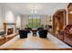 Bright living room with fireplace, wainscotting, and a large window overlooking the lawn at 3685 Paces Ferry Nw Rd, Atlanta, GA 30327
