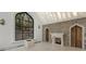 Elegant living room with a grand arched window and a stone fireplace creating a cozy, inviting atmosphere at 3685 Paces Ferry Nw Rd, Atlanta, GA 30327