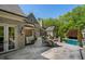Outdoor patio with a built-in barbecue area and seating, with views of the in-ground pool at 3685 Paces Ferry Nw Rd, Atlanta, GA 30327