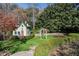 A backyard playhouse and play area includes a slide, trampoline, and green lawn at 3685 Paces Ferry Nw Rd, Atlanta, GA 30327