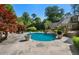 Beautiful in-ground pool, with a waterfall feature, is surrounded by a stone patio and lush landscaping at 3685 Paces Ferry Nw Rd, Atlanta, GA 30327