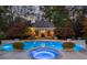 A tranquil pool area with a spa and lush landscaping surrounding it at 3685 Paces Ferry Nw Rd, Atlanta, GA 30327