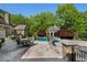 Outdoor patio with table, chairs, and barbecue area with access to the in-ground pool and pool house at 3685 Paces Ferry Nw Rd, Atlanta, GA 30327