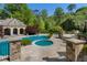 In-ground pool and spa with stone surround and poolhouse offer a luxurious outdoor experience at 3685 Paces Ferry Nw Rd, Atlanta, GA 30327