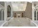 Sunroom with glass ceiling and large windows, featuring a fireplace at 3685 Paces Ferry Nw Rd, Atlanta, GA 30327