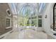 Sunroom with domed glass roof, tile floors, and views of the landscaped yard at 3685 Paces Ferry Nw Rd, Atlanta, GA 30327
