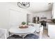 Bright dining area with white table and chairs in kitchen at 211 Morris Ln, Woodstock, GA 30188