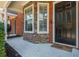 Inviting front porch with stone accents and black door at 211 Morris Ln, Woodstock, GA 30188