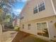 Townhome's backyard with a small patio and adjacent woods at 5431 Village Green Sq # 1018, Norcross, GA 30093