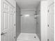 Updated shower with gray walls and built-in shelving at 5431 Village Green Sq # 1018, Norcross, GA 30093