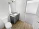 Modern bathroom with gray vanity, granite countertop, and updated fixtures at 5431 Village Green Sq # 1018, Norcross, GA 30093