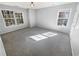 Bright bedroom with gray carpeting and two large windows at 5431 Village Green Sq # 1018, Norcross, GA 30093