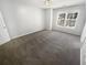 Bright bedroom featuring gray carpeting and a large window at 5431 Village Green Sq # 1018, Norcross, GA 30093