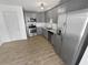 Modern kitchen with gray cabinets and stainless steel appliances at 5431 Village Green Sq # 1018, Norcross, GA 30093
