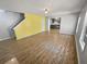 Open living area with hardwood floors and a view into kitchen at 5431 Village Green Sq # 1018, Norcross, GA 30093