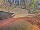 Private patio with a retaining wall and wooded backdrop at 5431 Village Green Sq # 1018, Norcross, GA 30093