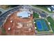 Aerial view showing new home construction underway within a community and next to newly constructed tennis courts at 551 Southland Cir, Canton, GA 30115