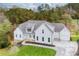 Two story white farmhouse with gray roof, stone accents, and detached garage at 113 Creekview Ln, Canton, GA 30115