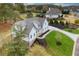 Two story white farmhouse with gray roof and stone accents nestled in a wooded neighborhood at 113 Creekview Ln, Canton, GA 30115