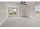 Well-lit bedroom with carpet, ceiling fan and multiple windows at 113 Creekview Ln, Canton, GA 30115