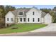 White farmhouse exterior with landscaping and a paved driveway at 113 Creekview Ln, Canton, GA 30115