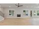 Bright living room featuring hardwood floors, fireplace, and access to backyard at 113 Creekview Ln, Canton, GA 30115