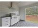 Outdoor kitchen with stainless steel grill and white cabinets at 113 Creekview Ln, Canton, GA 30115