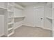 Large walk-in closet with built-in shelves and hanging rods at 113 Creekview Ln, Canton, GA 30115