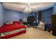Bedroom with a red bedspread and large TV at 3059 Sorrento Sw Cir, Atlanta, GA 30331