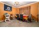 Dining room with a table for four and orange walls at 3059 Sorrento Sw Cir, Atlanta, GA 30331