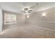 Carpeted bedroom featuring neutral walls, white trim, natural light, and a ceiling fan at 2065 Arbor Forest Sw Dr, Marietta, GA 30064