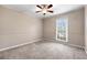 Comfortable bedroom with neutral walls, plush carpet, ceiling fan, and natural light at 2065 Arbor Forest Sw Dr, Marietta, GA 30064