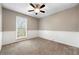 Neutral bedroom featuring plush carpet, paneled wainscoting, and a ceiling fan at 2065 Arbor Forest Sw Dr, Marietta, GA 30064