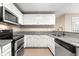 Modern kitchen featuring white cabinets, stainless steel appliances, and granite countertops at 2065 Arbor Forest Sw Dr, Marietta, GA 30064