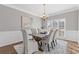 Formal dining room with hardwood floors, chandelier, and wainscoting at 5480 Landseer Way, Cumming, GA 30040