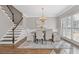 Elegant dining room with hardwood floors, chandelier, and large windows at 5480 Landseer Way, Cumming, GA 30040