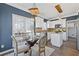 Modern kitchen with white cabinets, glass-top table, and pendant lighting at 5480 Landseer Way, Cumming, GA 30040