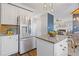 Bright kitchen featuring stainless steel refrigerator and granite island at 5480 Landseer Way, Cumming, GA 30040