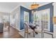Eat-in kitchen with white cabinets, glass-top table and pendant lighting at 5480 Landseer Way, Cumming, GA 30040