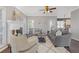 Cozy living room with hardwood floors, fireplace, and ceiling fan at 5480 Landseer Way, Cumming, GA 30040