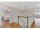 Upstairs hallway with hardwood floors and staircase at 5480 Landseer Way, Cumming, GA 30040