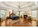 Main bedroom with fireplace, hardwood floors, and ample natural light at 830 Camden Park Ne Ct, Atlanta, GA 30342