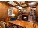 Home office with wood paneled walls, fireplace and hardwood floors at 830 Camden Park Ne Ct, Atlanta, GA 30342