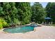 Inviting freeform pool with spa and lush landscaping at 830 Camden Park Ne Ct, Atlanta, GA 30342