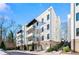 Modern three-story building with white brick exterior and private balconies at 1494 Red Fox Ne Dr # D, Atlanta, GA 30306