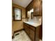 Bathroom with wood vanity, oval mirror, and tile floor at 3639 Holly Springs Rd, Rockmart, GA 30153